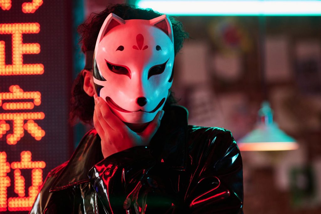 young-woman-in-fox-mask-standing-against-hieroglyp-2023-11-27-04-51-44-utc